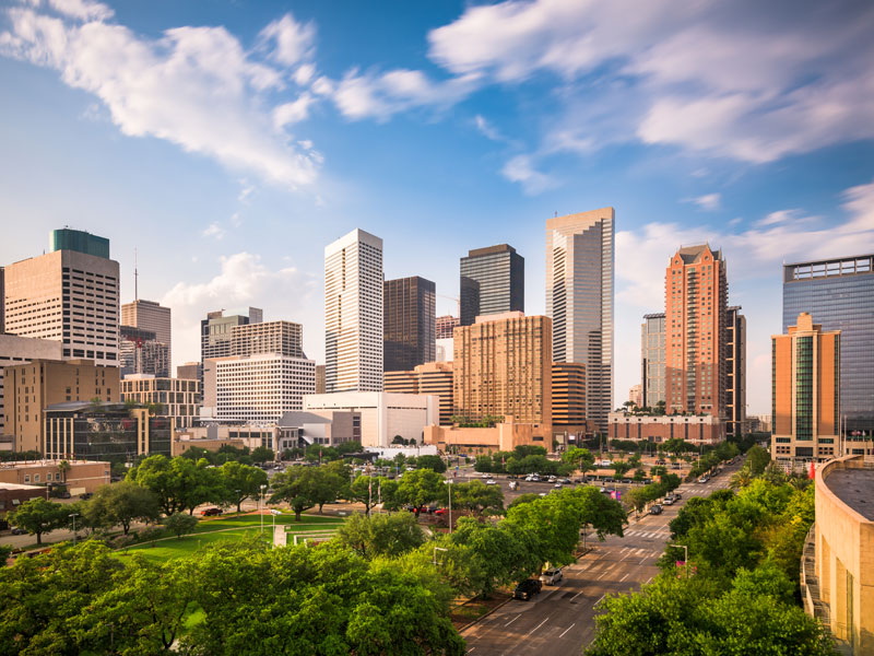 Houston city skyline with modern high-rise buildings and tree-lined streets